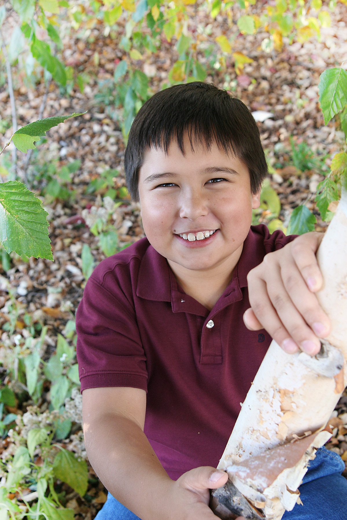 boy-in-tree-fall-leaves